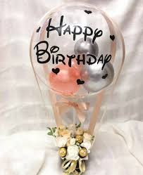 Stuffed 2 silver 1 pink balloon in Transparent Balloon Printed Happy Birthday with basket of 10 white roses and 4 ferrero