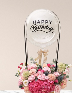 Transparent Balloon Printed Happy Birthday Tied with ribbons to a basket of 30 pink and white flowers