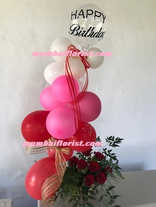 Pink red white balloons arrangement with roses and happy birthday balloon