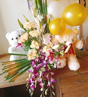 2 teddies 1 foot each with 8 gold white balloons basket 30 peach roses lilies and orchids with babys breath
