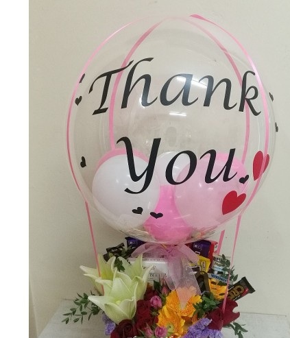 Balloon with Thank you print with basket of 2 liliy 5 gerberas 5 dairy milk chocolates
